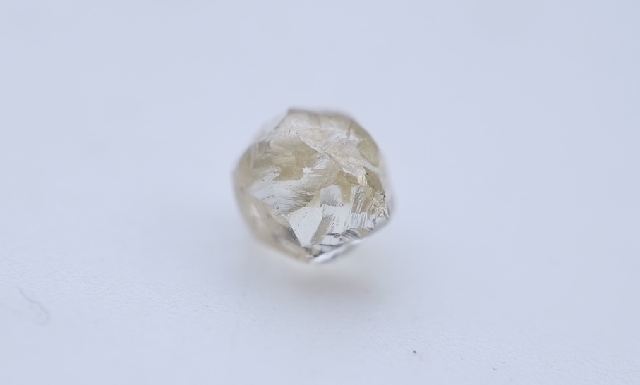 A rough diamond, with accompanying box and note, late 19th century